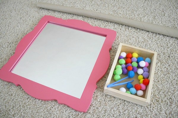 Toddler Activity: Invitation to play with pom poms and a mirror