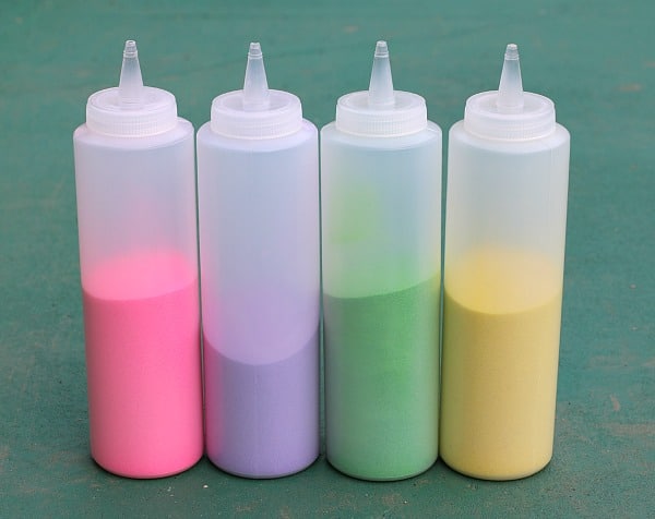 Squeeze bottles filled with colored sand for drawing outside