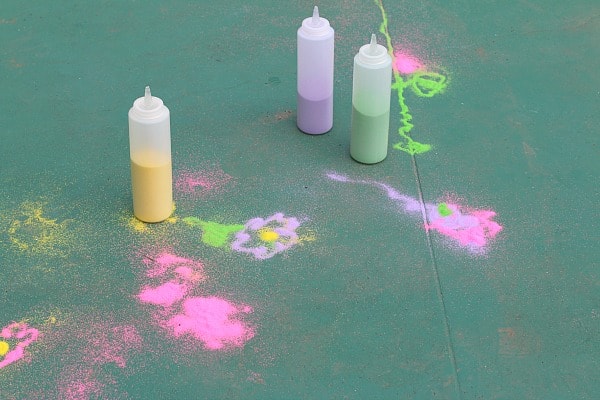 Squeeze bottles filled with colored sand for drawing outside