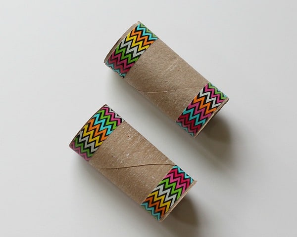 add colorful tape to toilet paper rolls to make binoculars