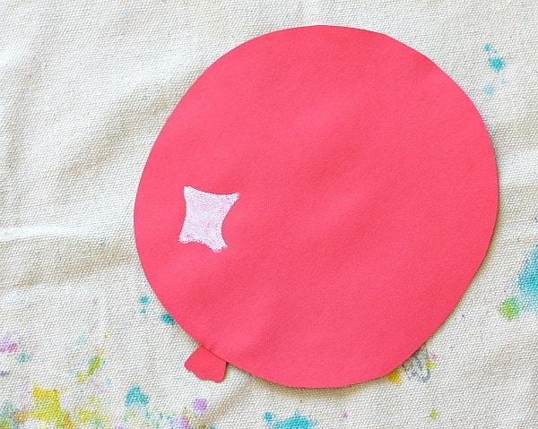 cut out a balloon shape from red construction paper