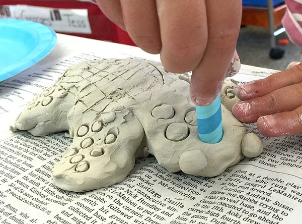 use a straw to make designs in your clay sea turtle art project for kids