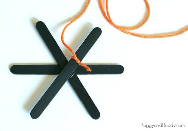 tie yarn to your popsicle stick spiderweb