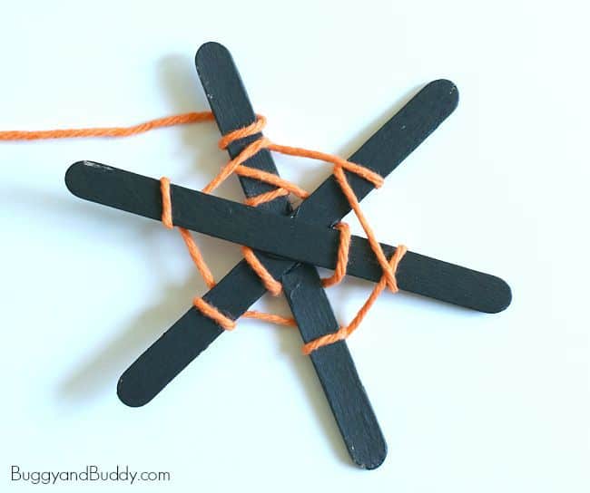 wrap the yarn around your popsicle stick spiderwebs