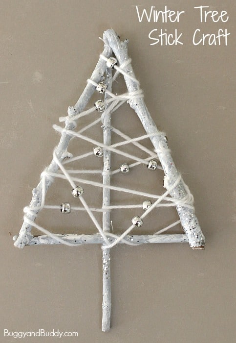 Make a winter tree craft for kids using yarn wrapped sticks! 