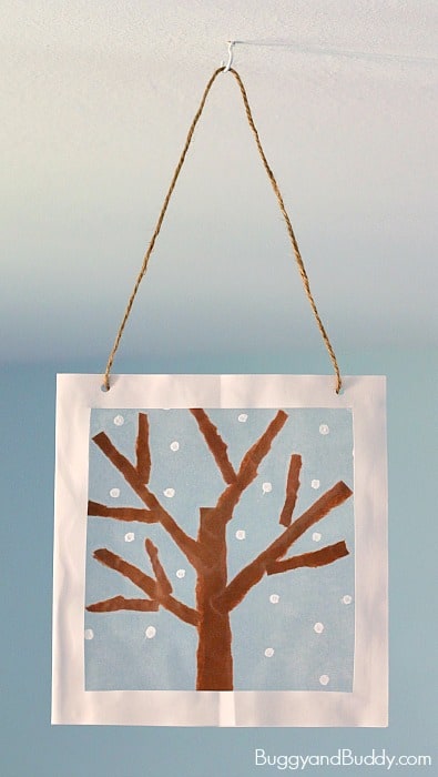 Winter Tree Suncatcher Craft for Kids using tear art and cotton swab painting- a fun winter art project for preschool, kindergarten, and elementary! ~ BuggyandBuddy.com