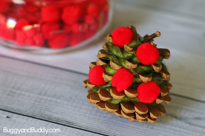 glue red pom poms to your pinecone for the apple tree craft for kids