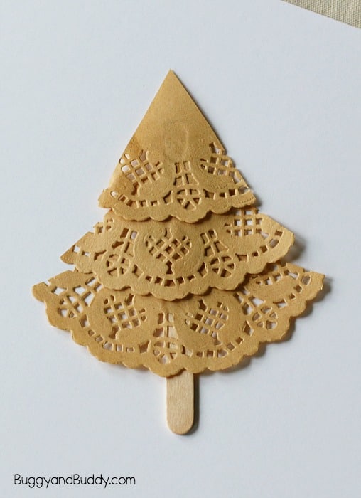 glue your doily pieces onto your popsicle stick to form your christmas tree craft