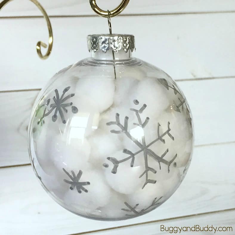 Winter Snowflake Ornament Craft for Kids: Use pom poms and clear plastic bulbs to make these easy and quick Christmas ornaments. Great fine motor practice and perfect for kids of all ages (toddler, preschool and up!) 