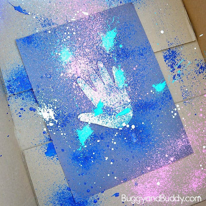 spray your galaxy colored paints onto the paper