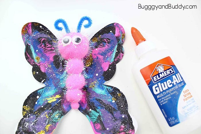 glue pompoms onto your butterfly craft as well as pipe cleaner antennae and googly eyes