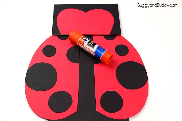 glue wings onto your paper bag ladybug