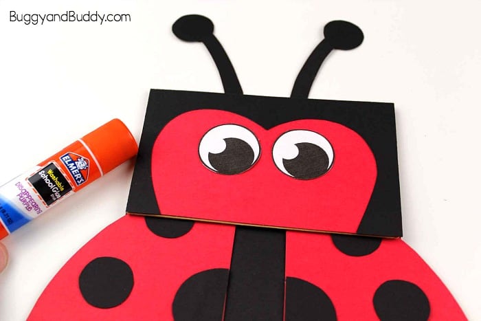 glue the eyes and antennae onto your paper bag ladybug puppet craft